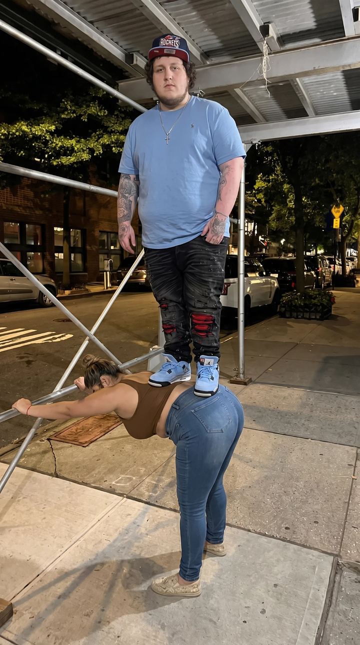 standing on a woman's back to reach scaffolding